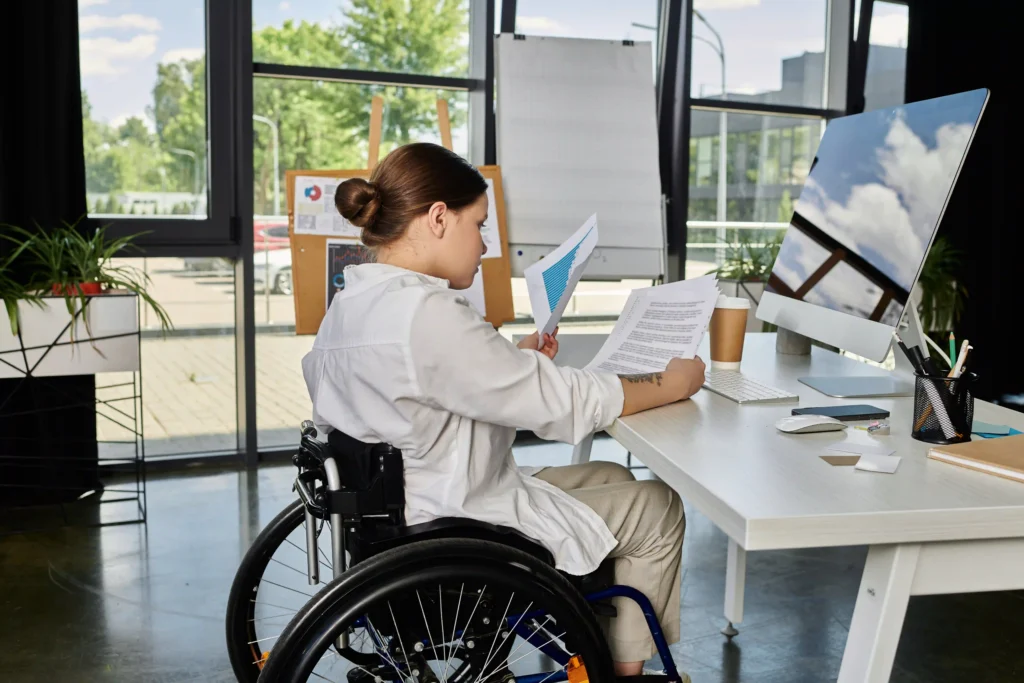 Business woman in wheelchair working at desk