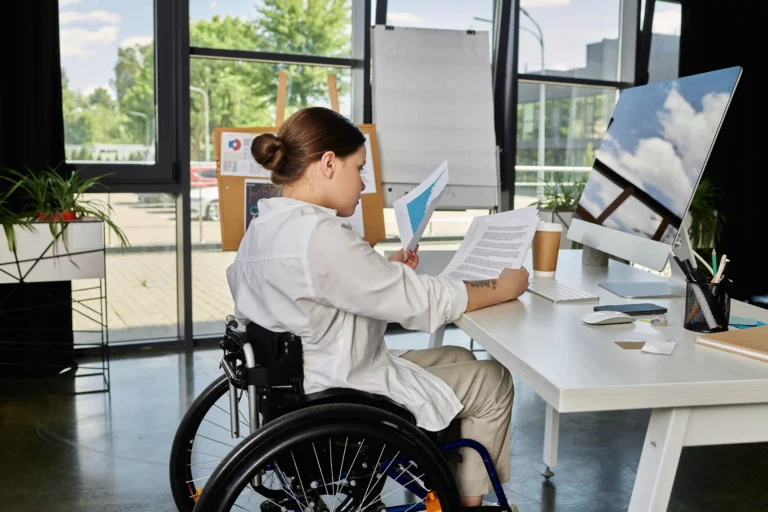 Business woman in wheelchair working at desk