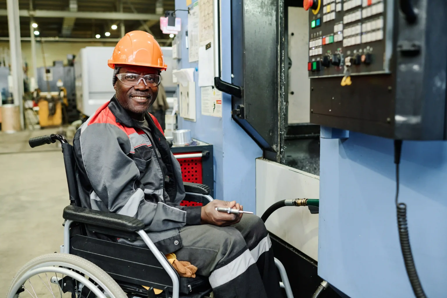 Wheelchair man operating machinery