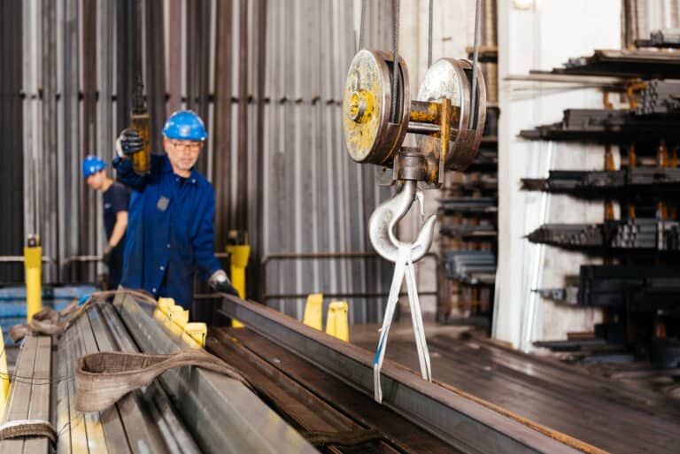 Steelworker operating crane in workshop