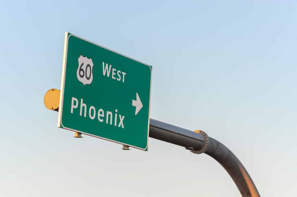 A green highway sign indicates the 60 freeway headed west toward Phoenix, Arizona